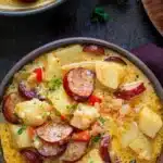 Bowl of delicious Cajun Potato Soup garnished with green onions and spices.